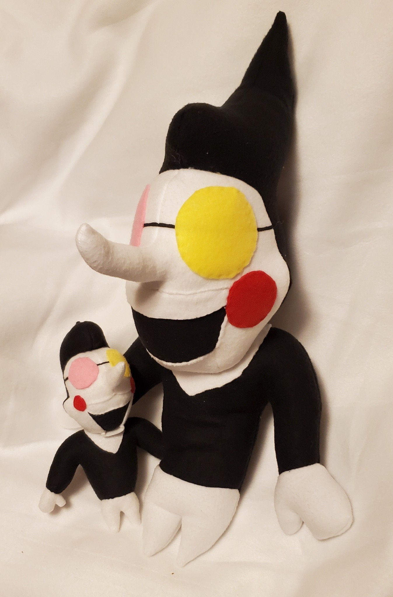 A photograph of a plush made by DayLikesCookies. The design is based on an indie-game puppet character.