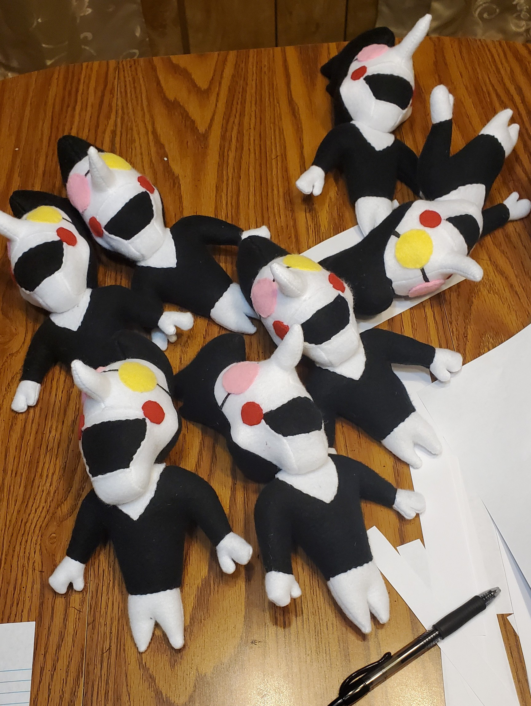 A photograph of several plush toys made by DayLikesCookies. The design is based on an indie-game puppet character.